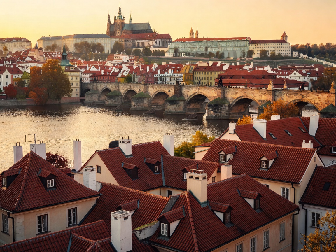 Historic Prague rooftops and bridge in warm light